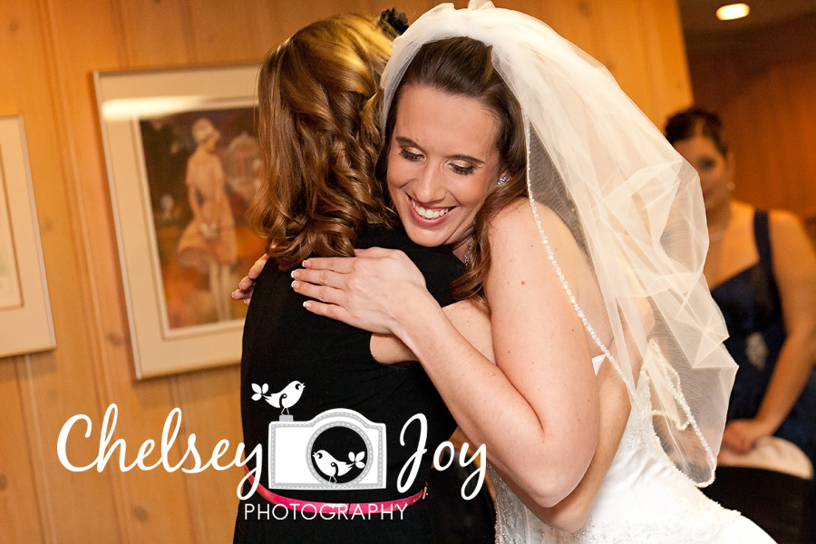 Bride hugs her friend at her wedding in West Chicago. 