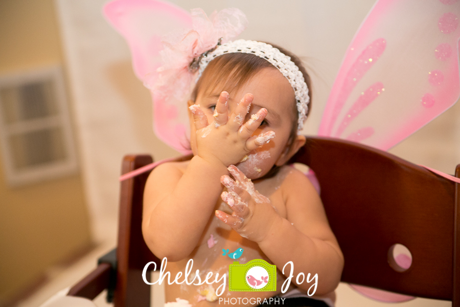 Baby J eats cake at her first birthday party.