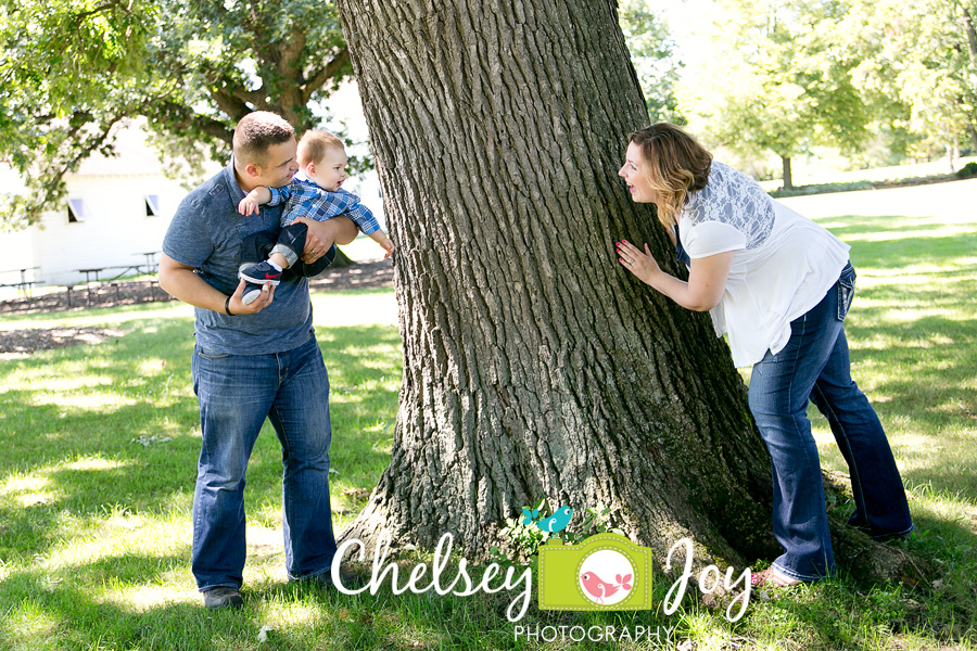 A family plays with their son, Jackson during a 1 year photo session.