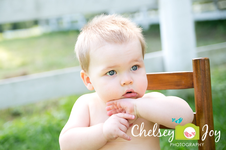 Jackson sits in a rocking chair as his 1 year photo session. 