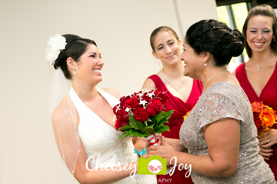 Mother of bride handing over bouquet at DeKalb wedding. 