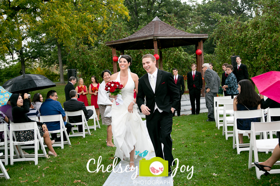 Bride and groom walking down aisle at outdoor DeKalb wedding. 