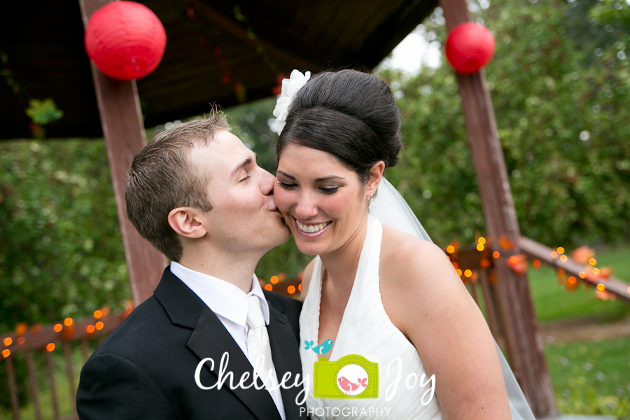 Groom giving bride kiss at Hopkins Park. 