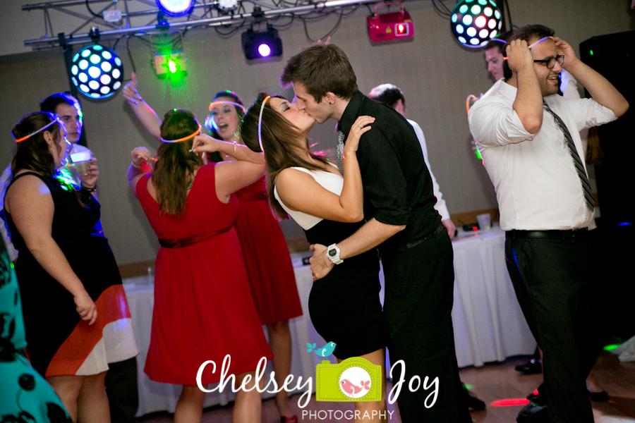 Couple kissing at wedding reception in DeKalb. 