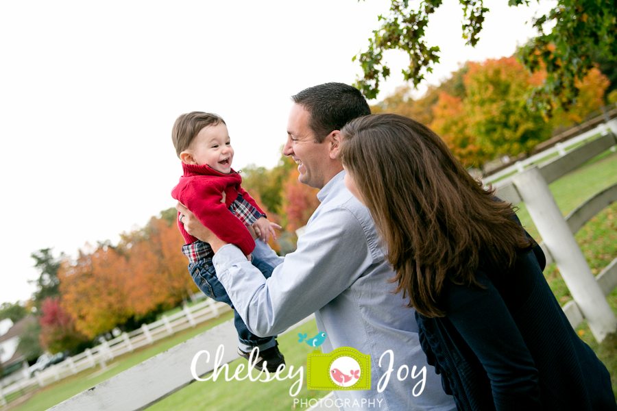 Parents play with little one during a fun photo session at the Danada Equestrian Center.