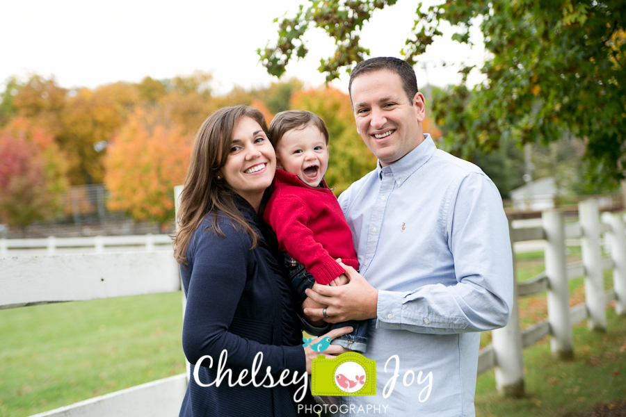 Family smiles for a fall portrait photo.