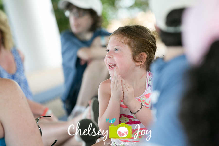 Child smiles while listening to a speaker at SeaWorld in Orlando. 