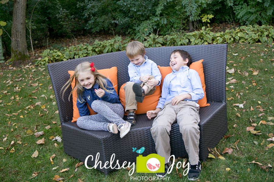 The three kids giggle while hanging out in their backyard in Wheaton. 