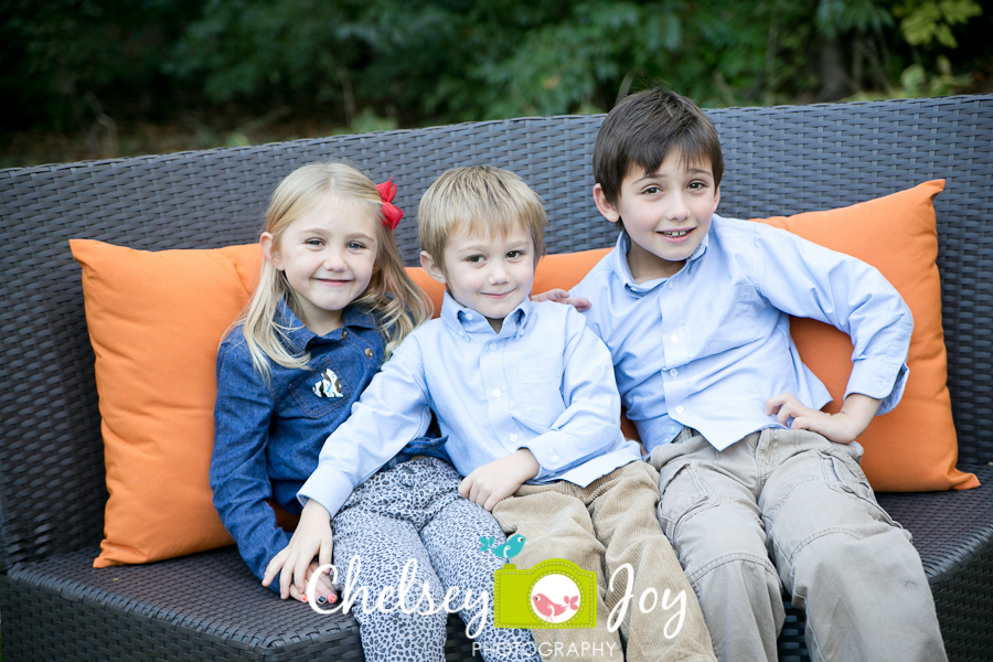 The three kids smile during a Wheaton portrait session. 