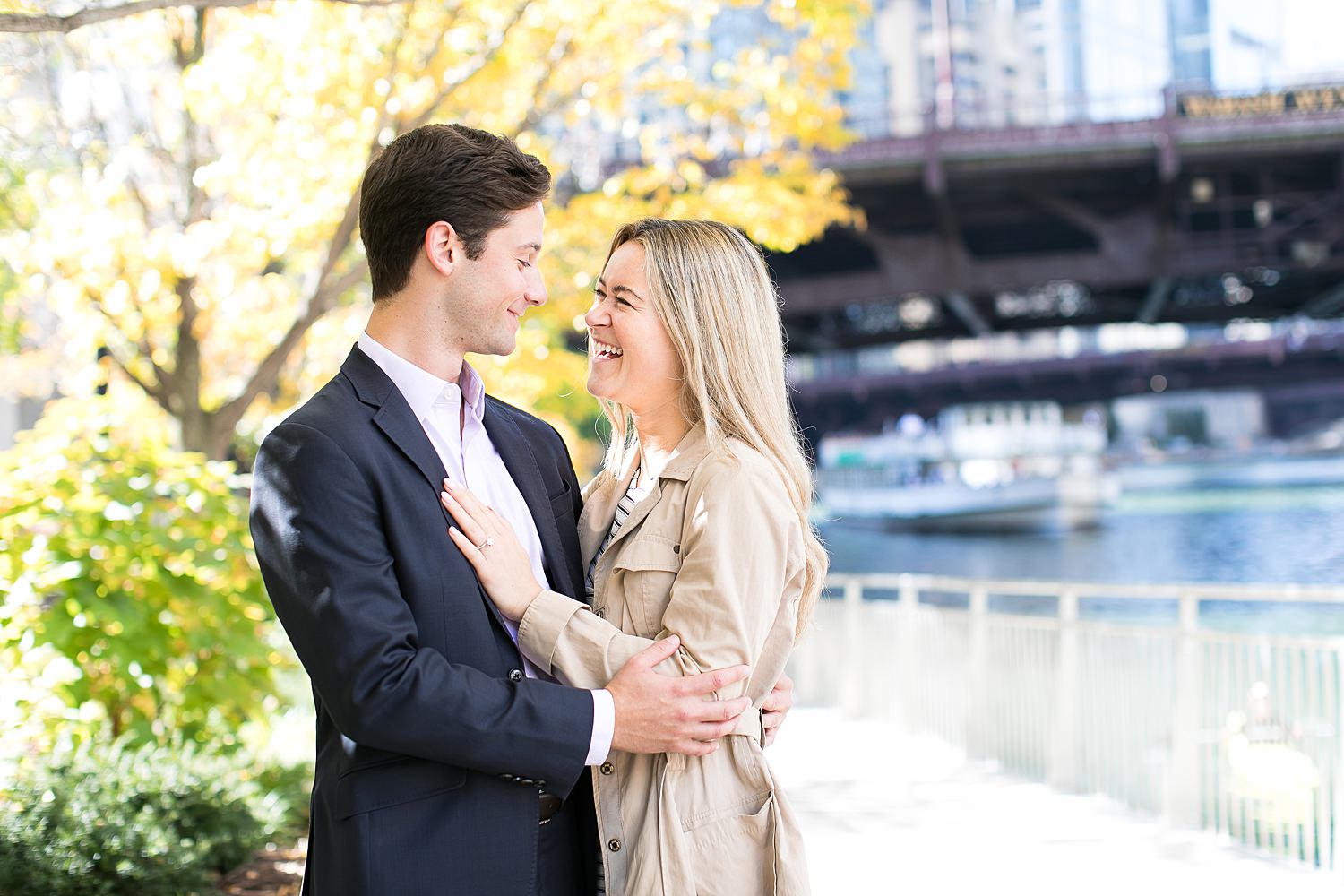 Evan and Julia take photos by Chicago Riverwalk after their Chicago proposal.