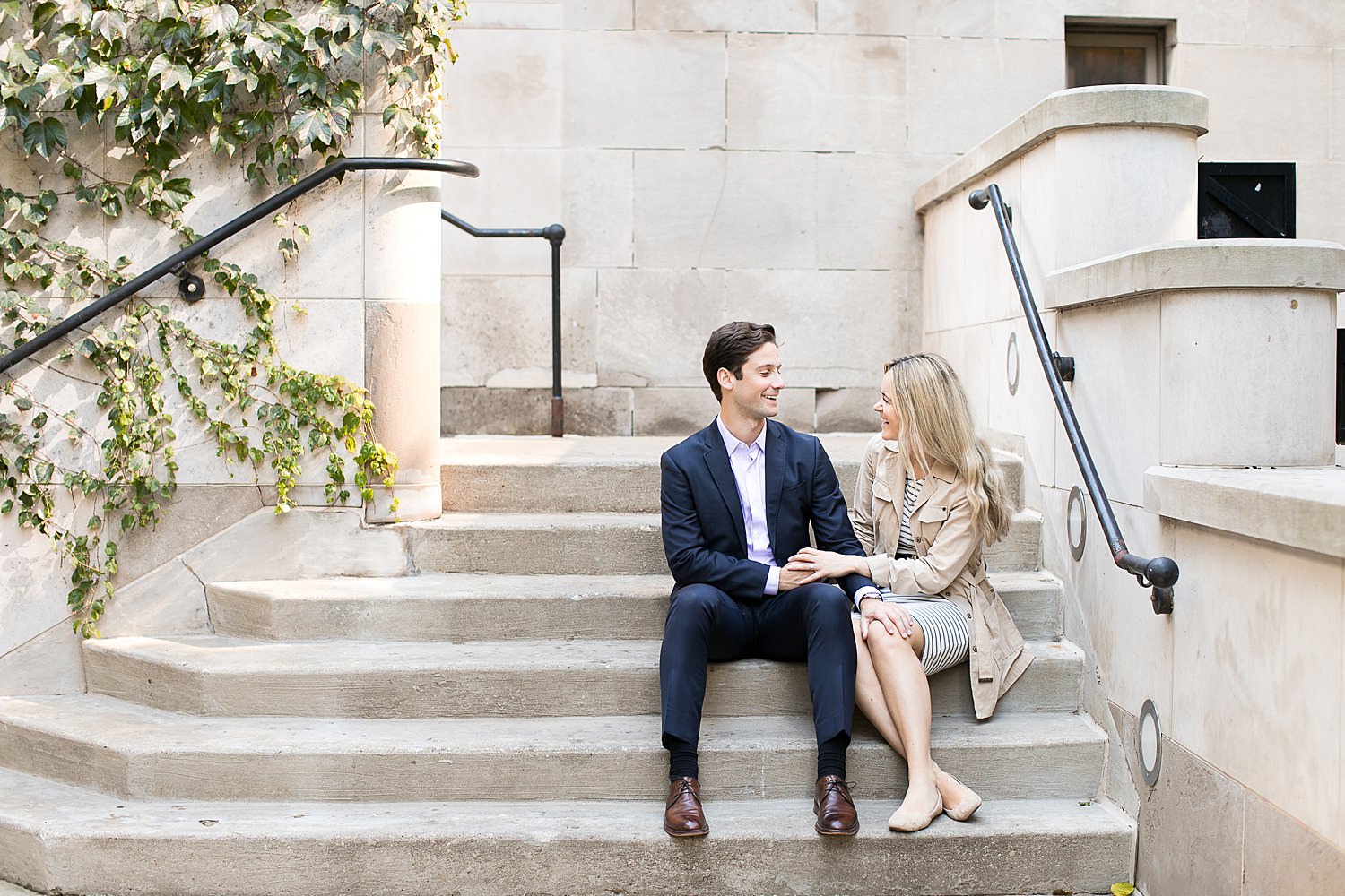 Evan and Julia sit on steps by the Chicago Riverwalk.