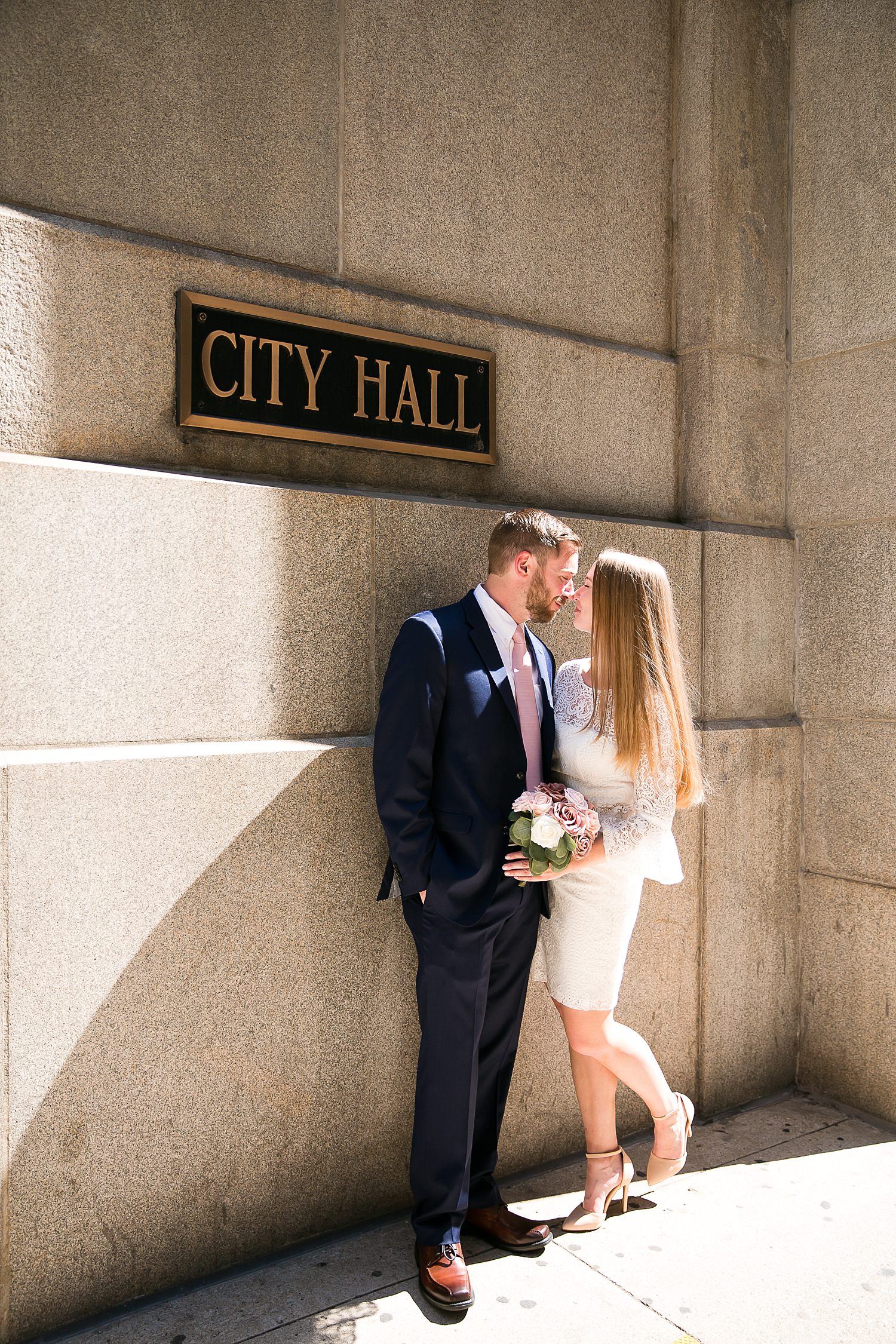 Couple stands outside city hall after their courthouse wedding in Chicago.