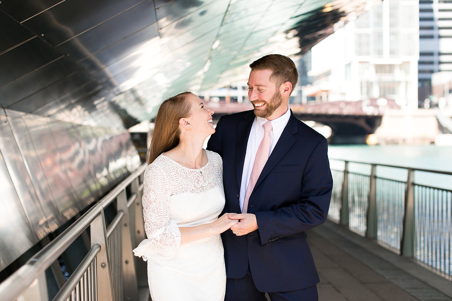 Couple laughs by the Chicago Riverwalk.