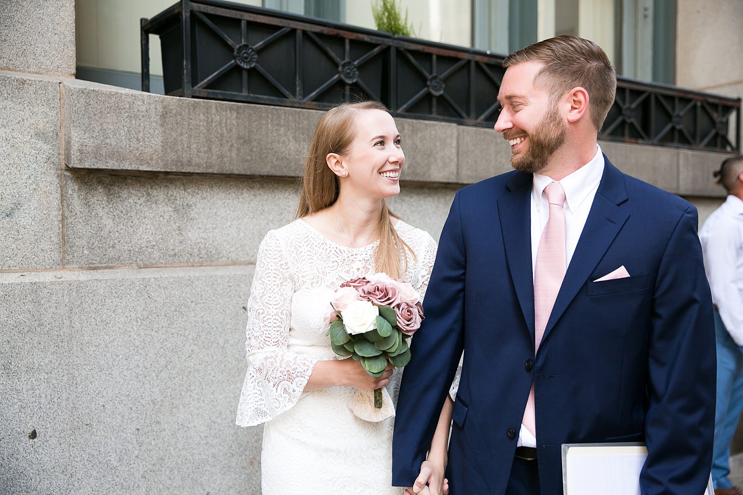 Couple waits outside city hall for their courthouse wedding in Chicago.