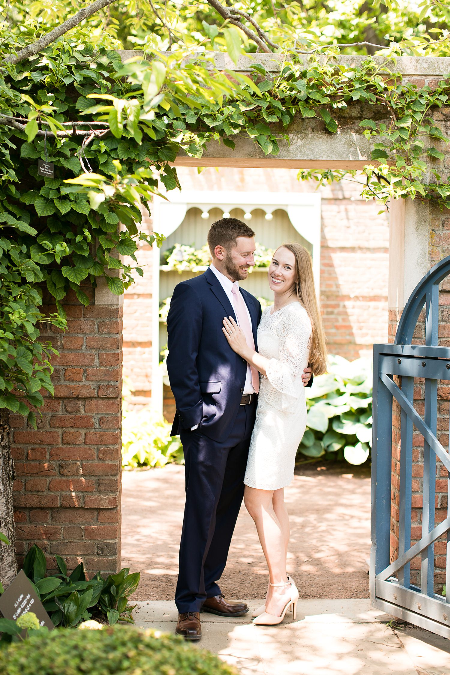 Couple stands by gate at Chicago Botanic Garden.