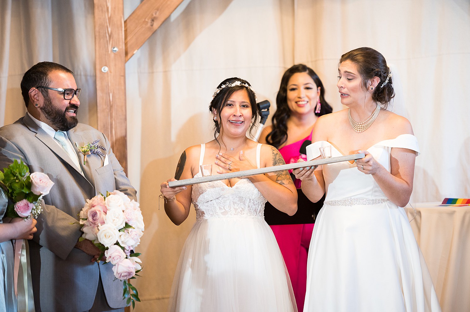 Brides taking tequila shot at wedding ceremony at The Haight.