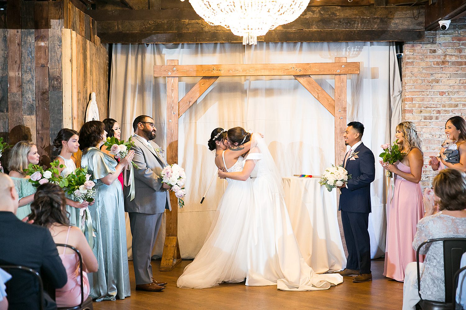 Brides kissing at the end of wedding ceremony at The Haight.