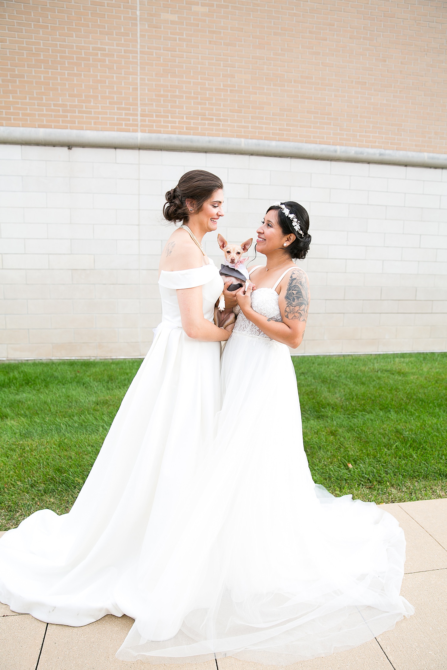 Brides holding their dog named Olive.