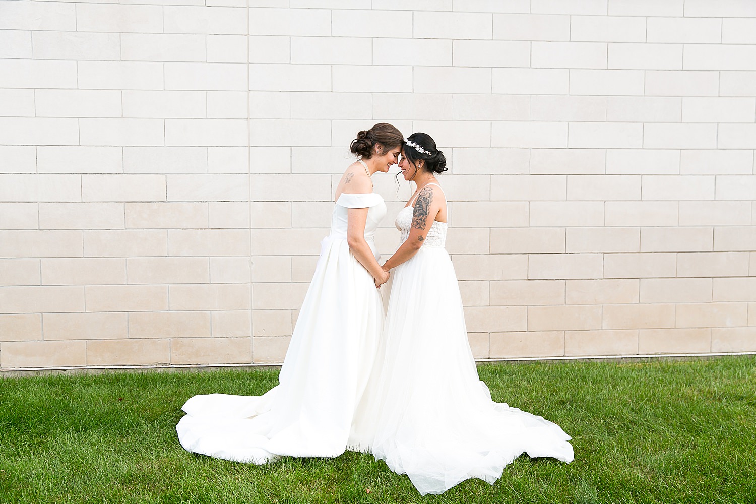 Brides holding hands outside of their wedding venue, The Haight.