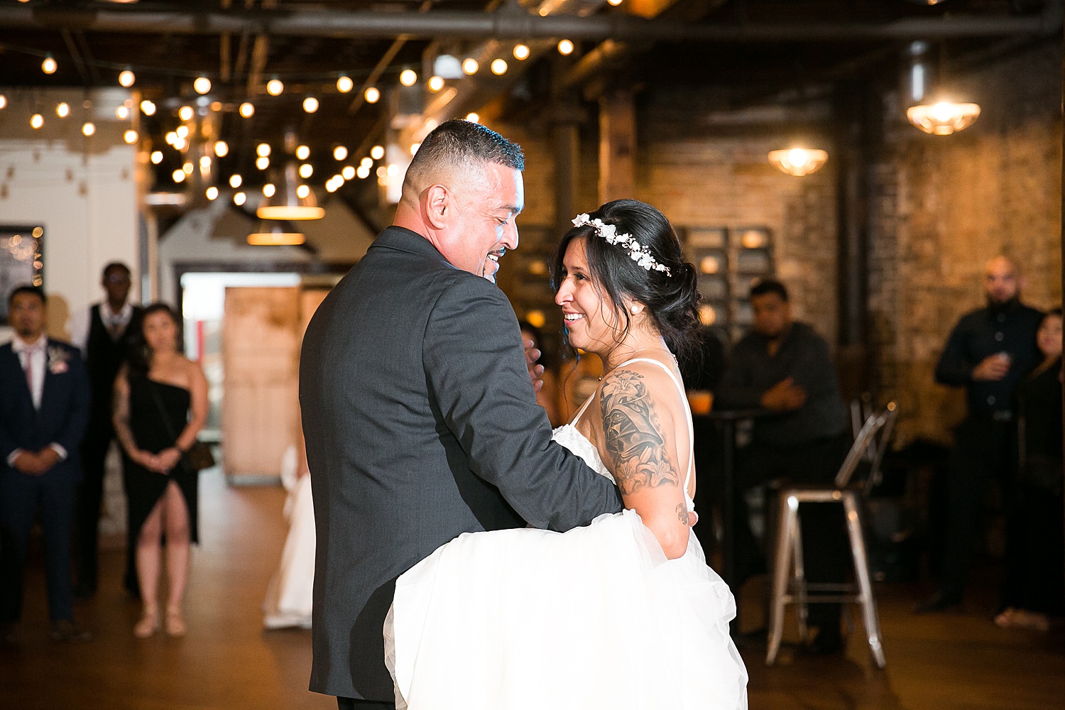 Monica dances with her dad at wedding reception.