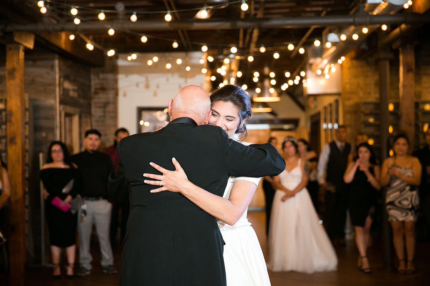 Stephanie dances with dad at wedding reception.