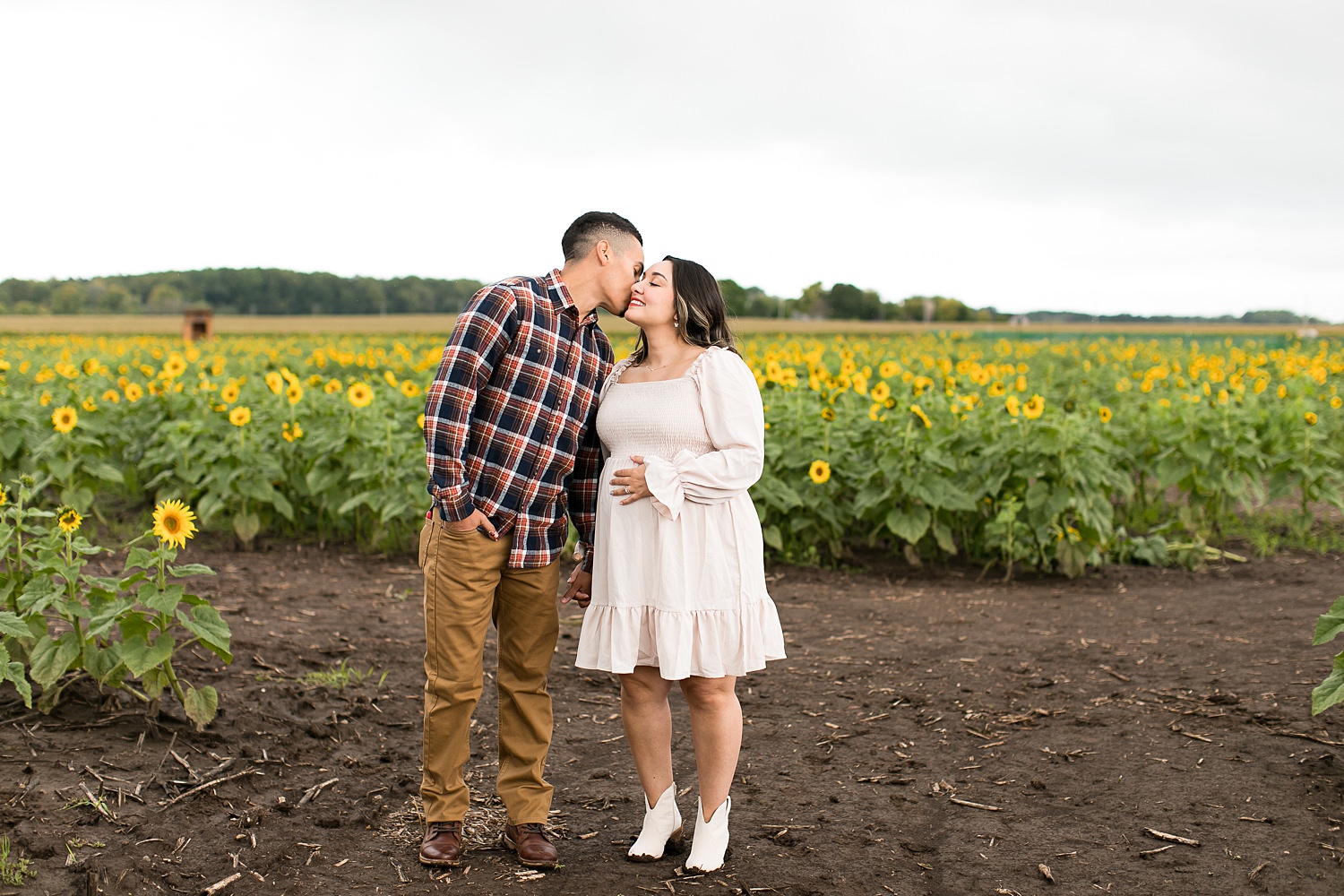 Couples kisses in sunflower field