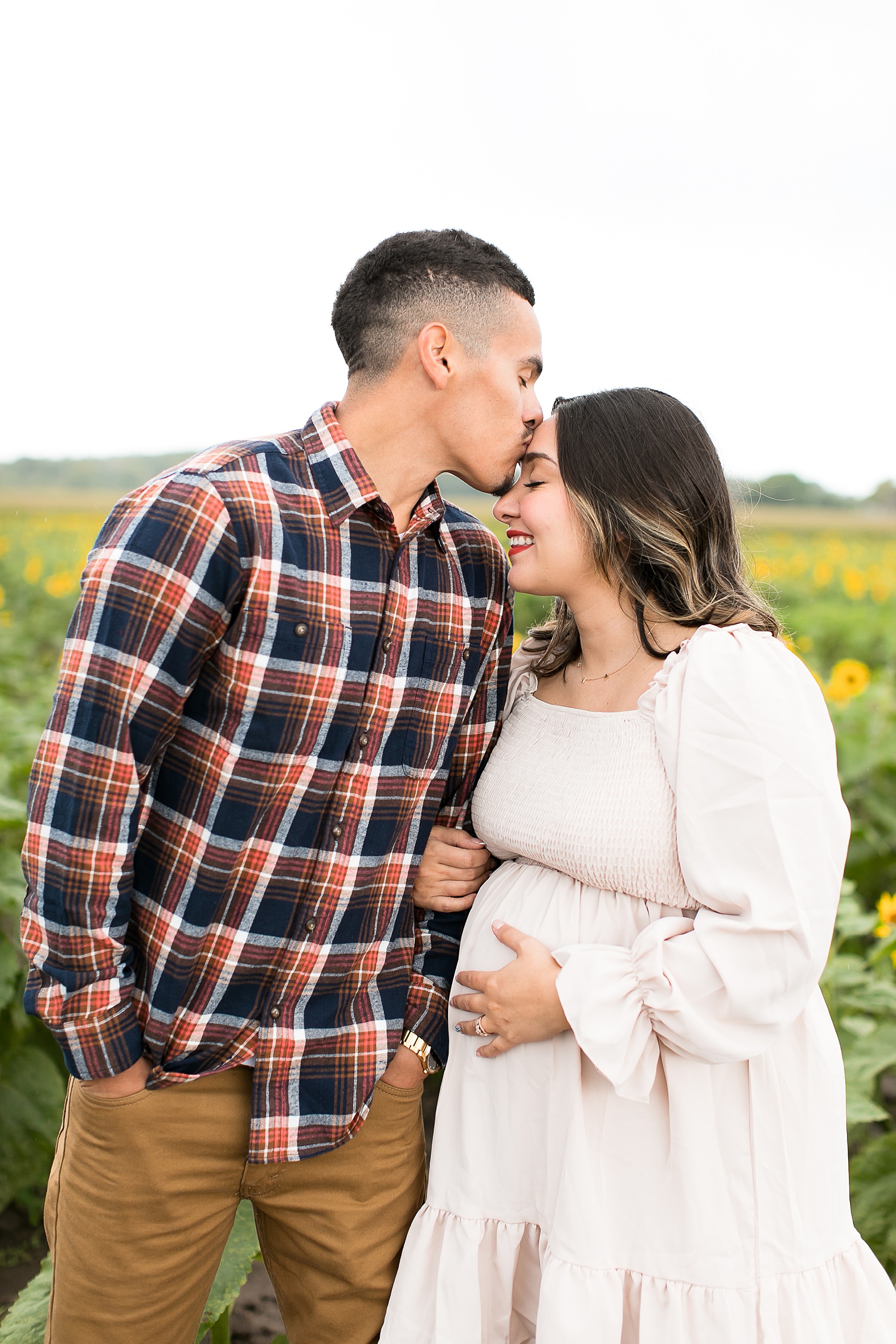 Couple kisses in sunflower field