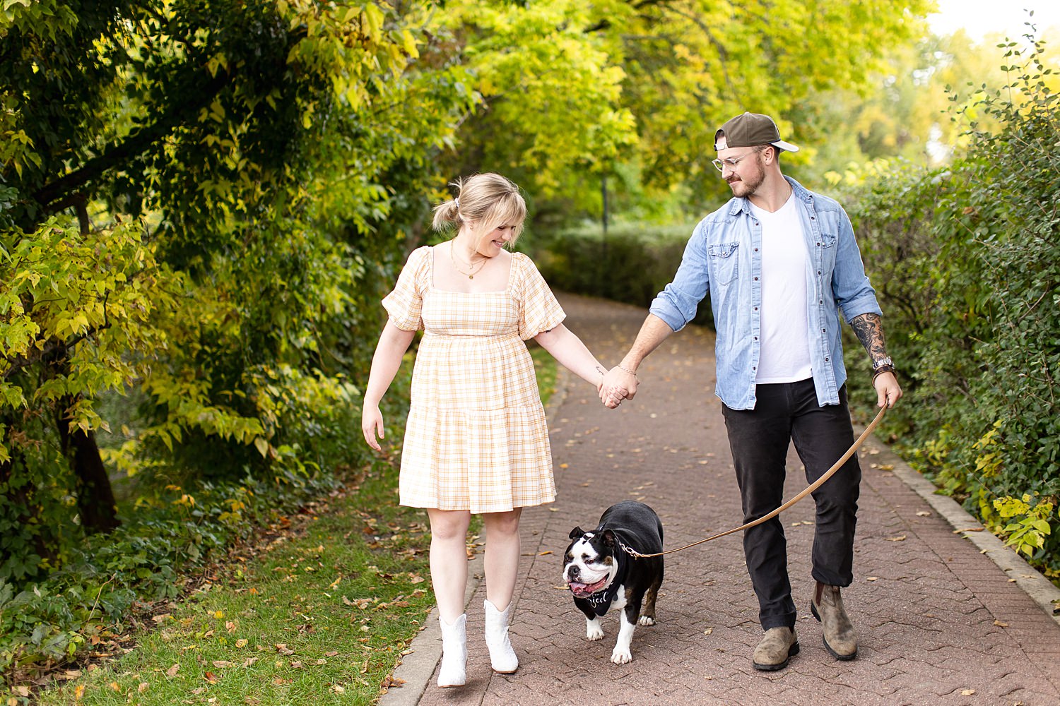 Couple walks with bulldog in Nashville