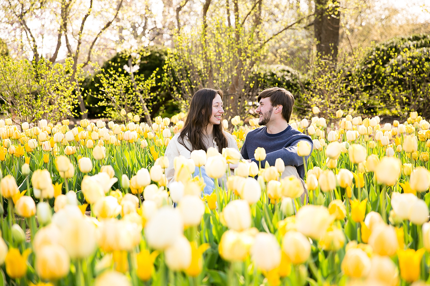 Couple sits in tulip field