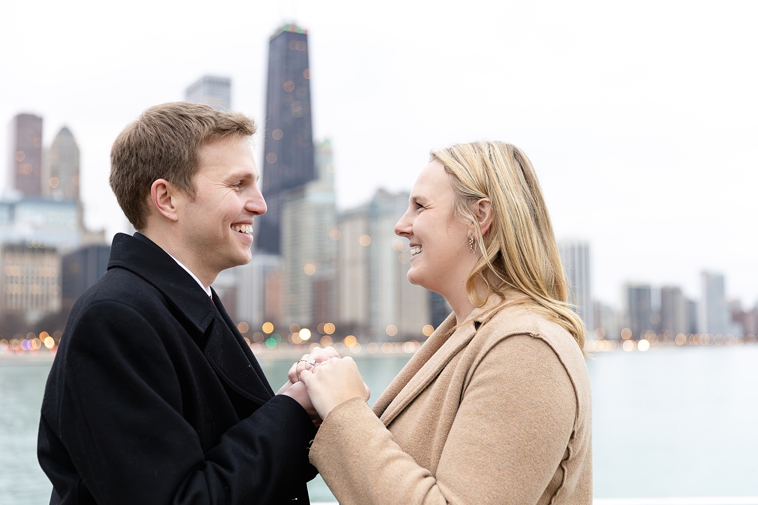 Couple holds hands during engagement photos.