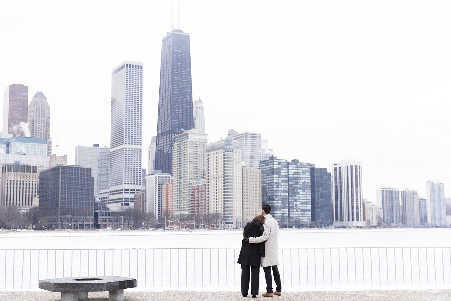 Couple watches Chicago skyline.