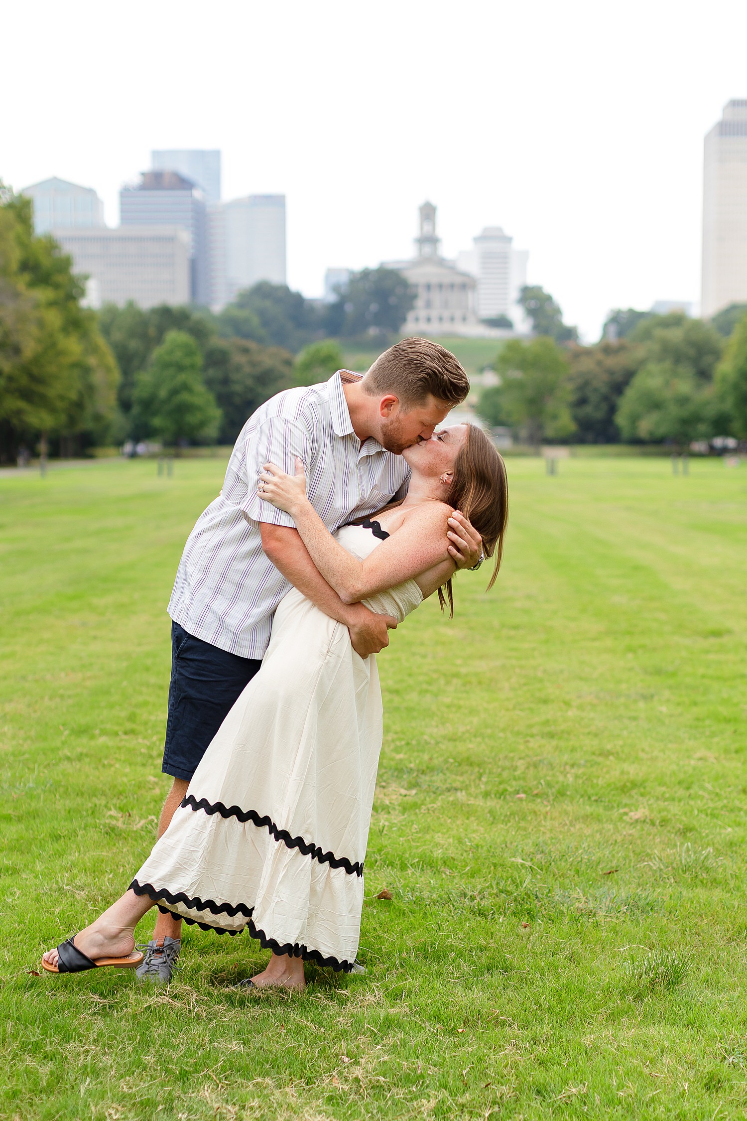 Engaged couple kisses at Bicentennial Capitol Mall State Park a favorite proposal spot in Nashville