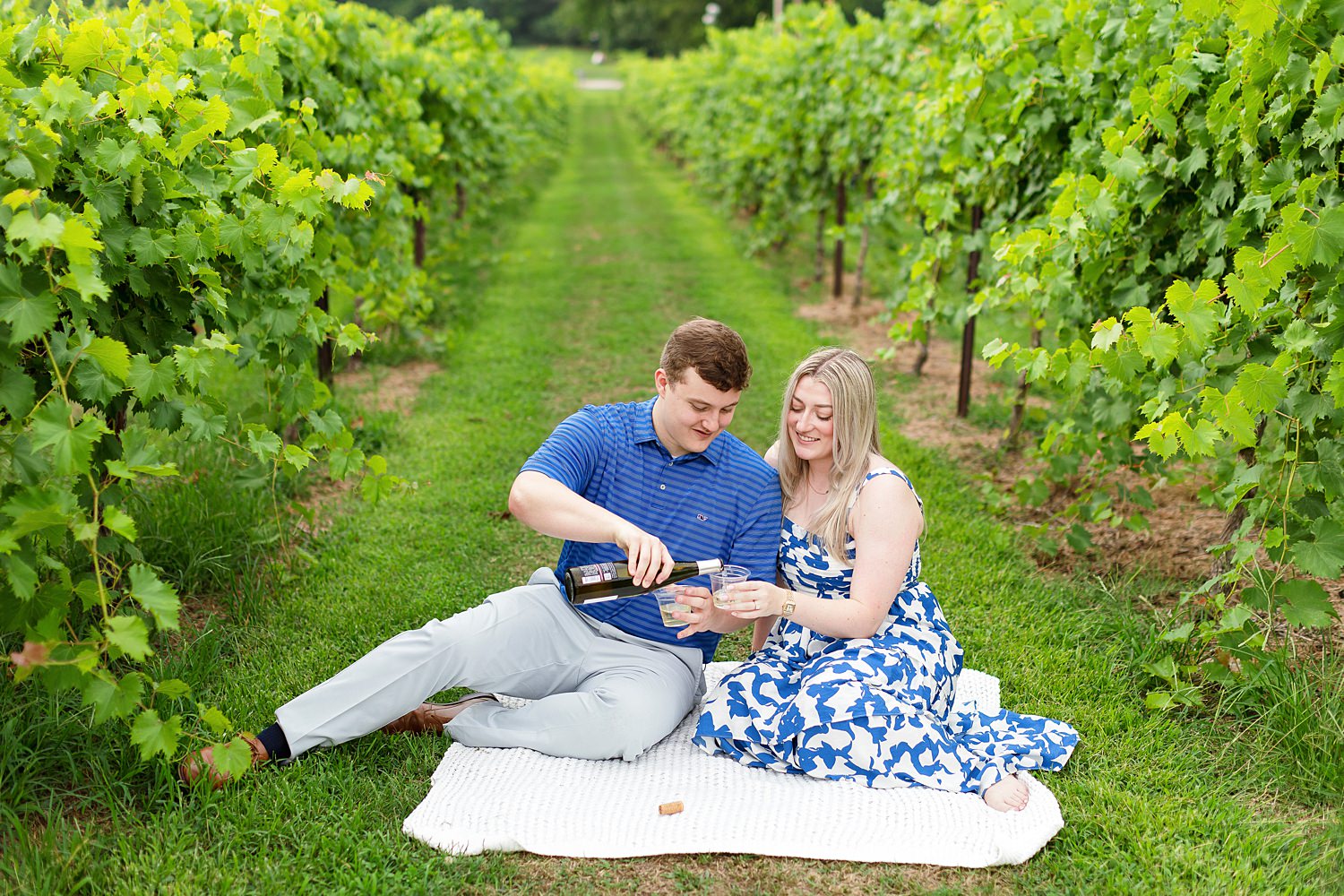 Engaged couple drinks wine at Arrington Vineyards