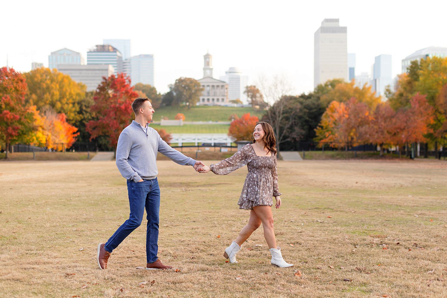 Engaged couple walks at Bicentennial Capitol Mall State Park in Nashville.