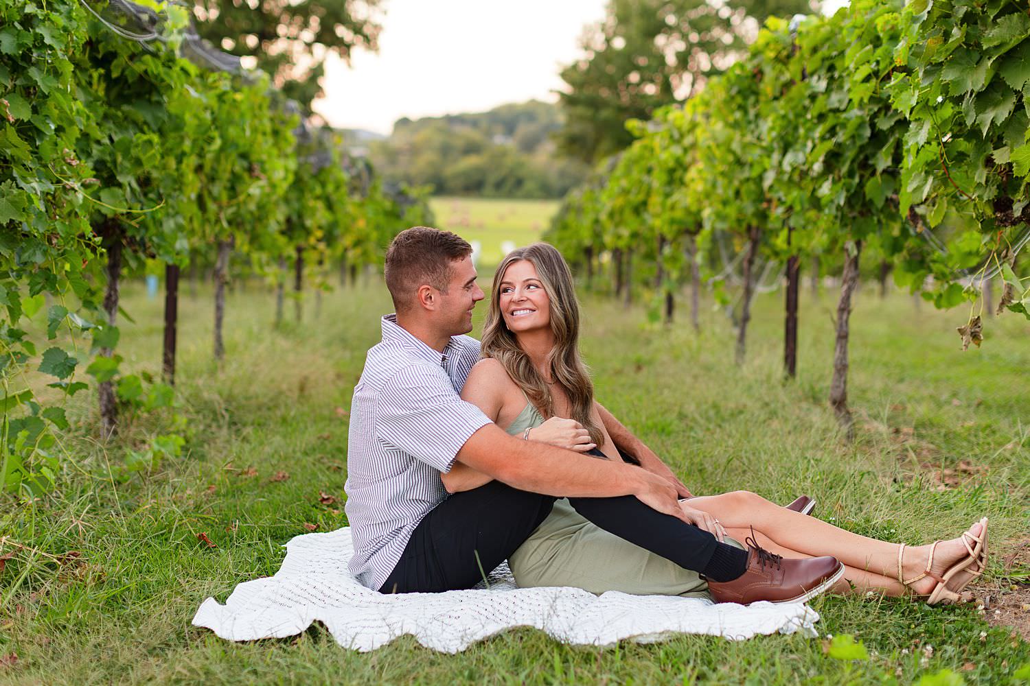 Couple sitting at Arrington Vineyards for Nashville engagement session.