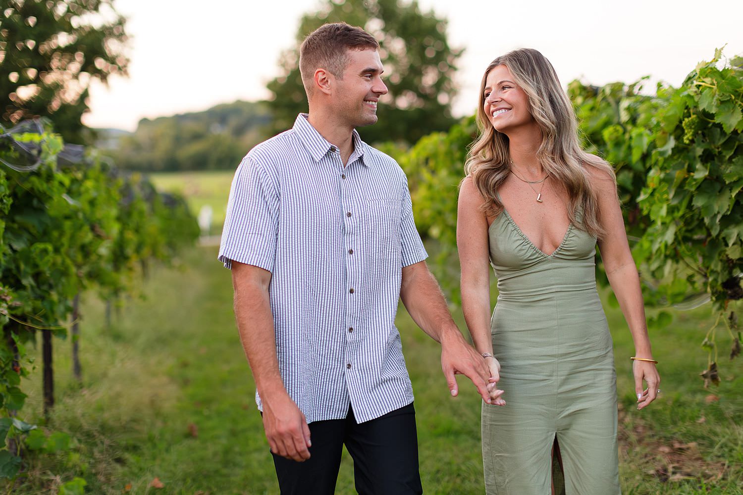 Engaged couple walking at Arrington Vineyards
