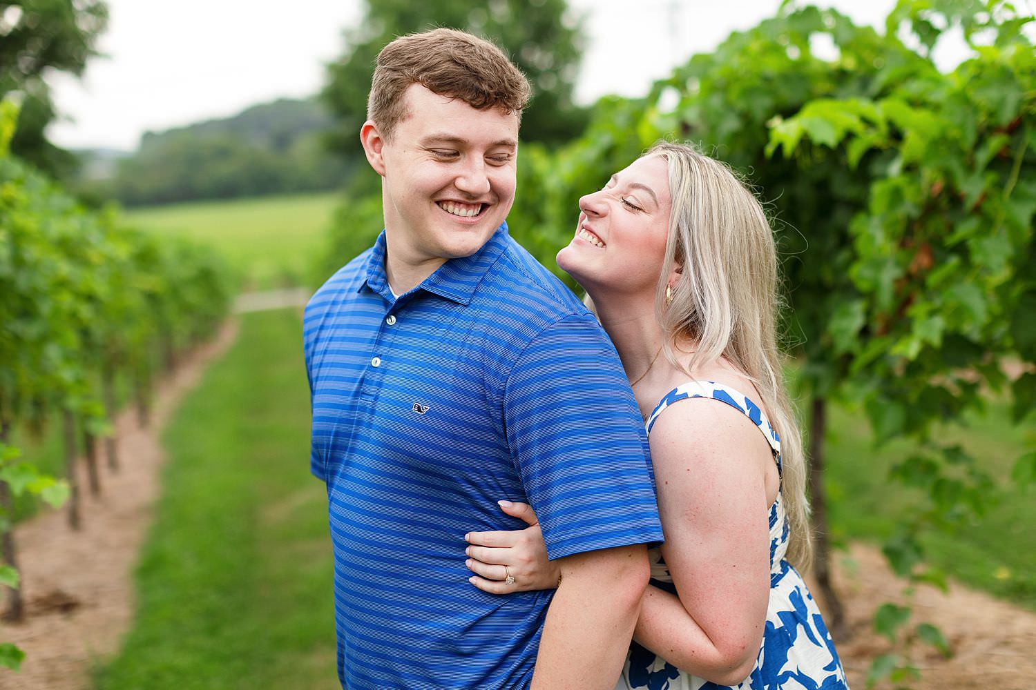 Engaged couple hugs at Arrington Vineyards.