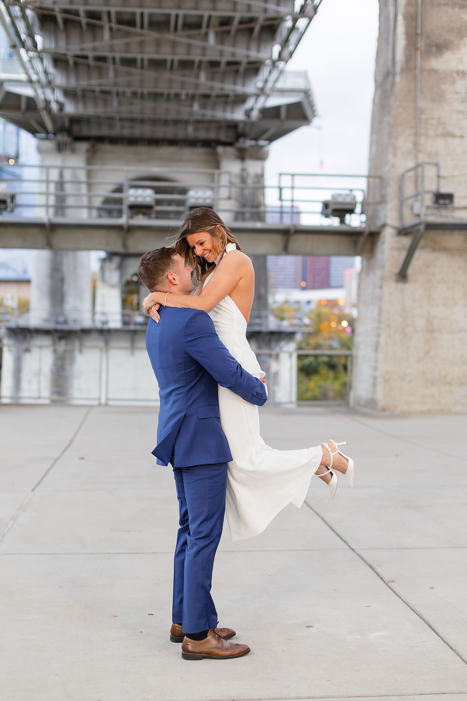 Nashville engagement photographer capturing couple under bridge in downtown Nashville.