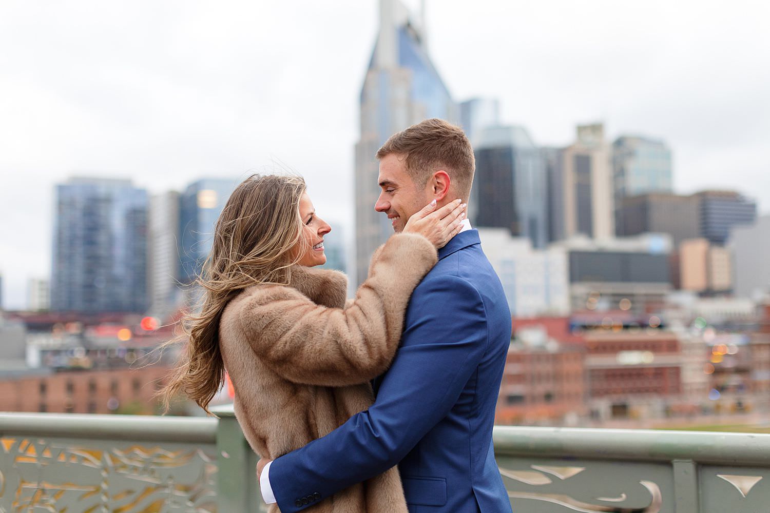 Engaged couple at Nashville pedestrian bridge.